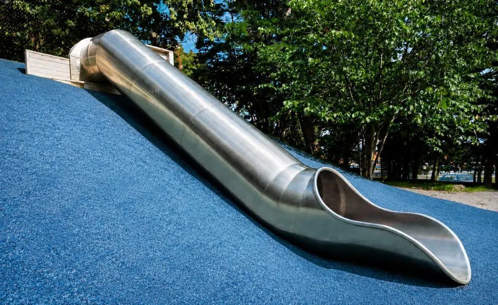 Stainless steel tunnel embankment slide on a mound by Landrec
